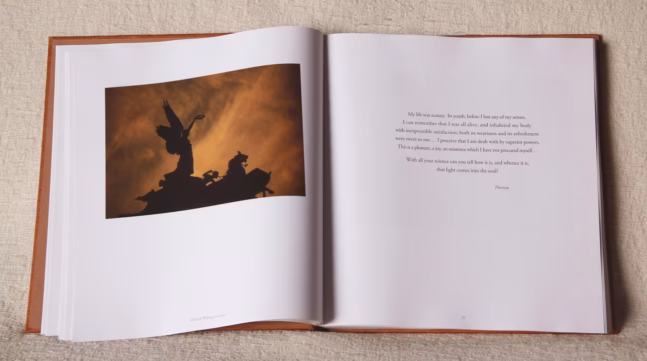 Opening Up spread — winged victory against a burning sky