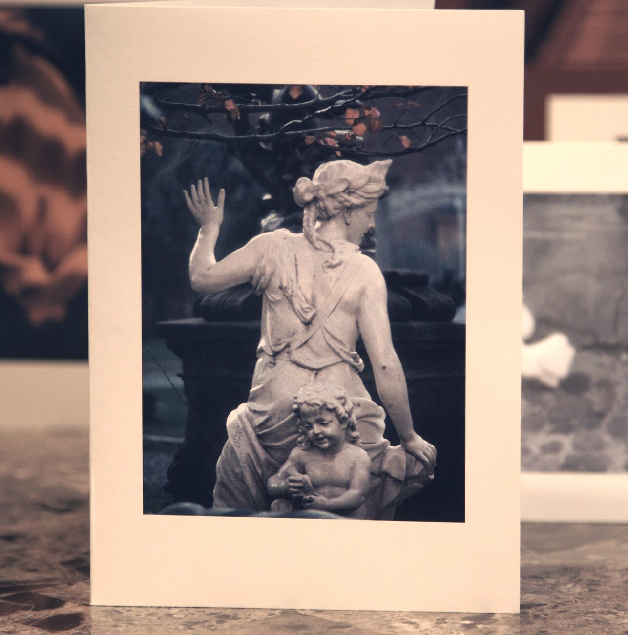 Watching Over card — garden statuary of a woman and child